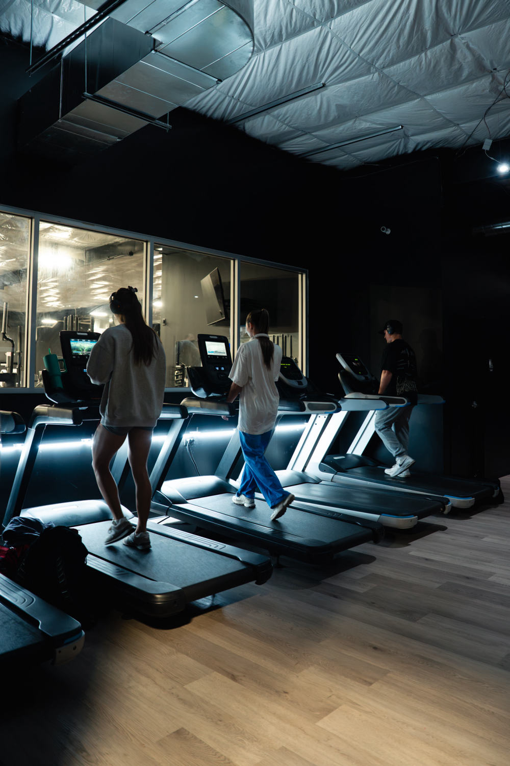 Members walking on the treadmills in the cardio area at The Forum