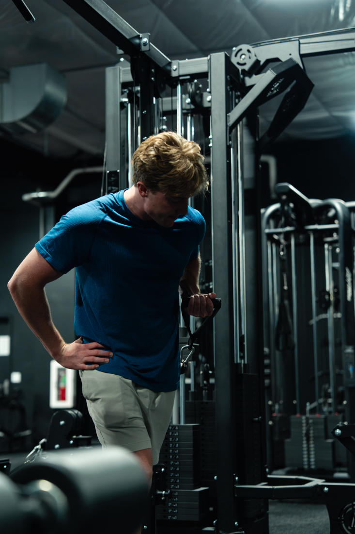 A member training at the cable machines at The Forum